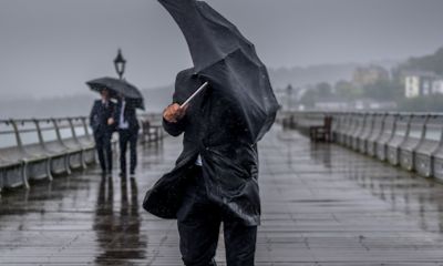image of a person holding an umbrella, hiding their face