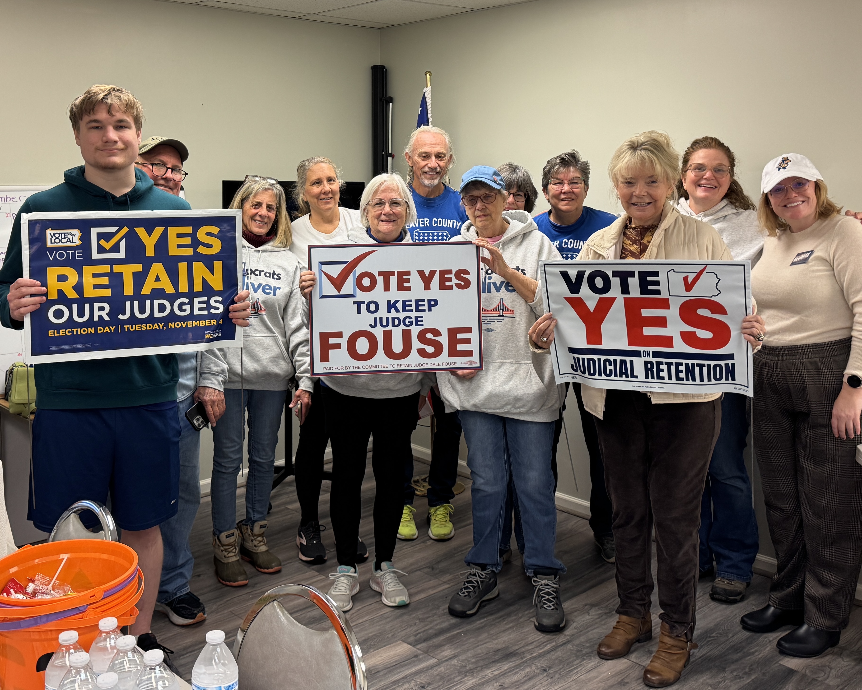 a dozen smiling volunteers holding Vote Yes signs