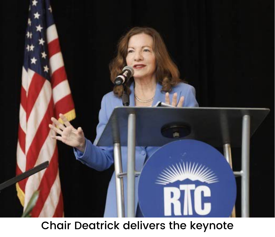 DNC Climate Council Chair Deatrick speaking at podium next to American flag at Nevada Extreme Heat Summit